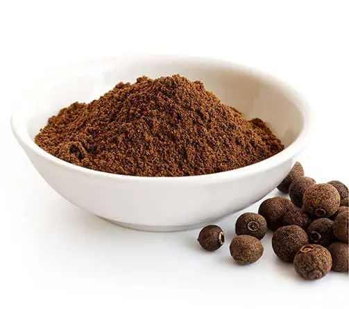 allspice berries and ground powder in a bowl