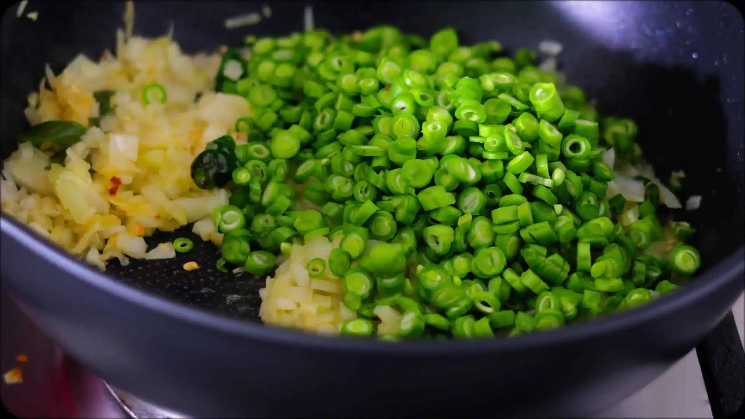 sauteeing onions and pole beans for making CousCous Fried Rice