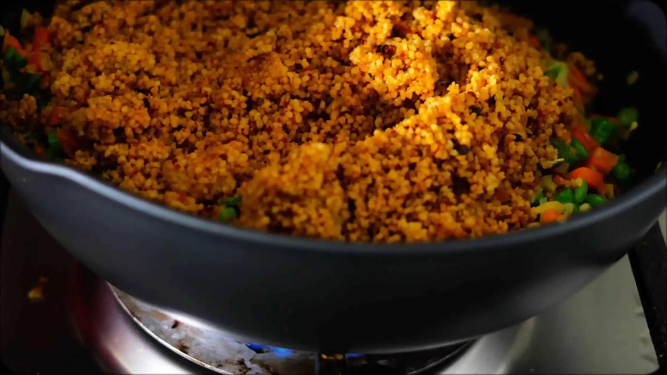 adding cooked couscous for making CousCous Fried Rice