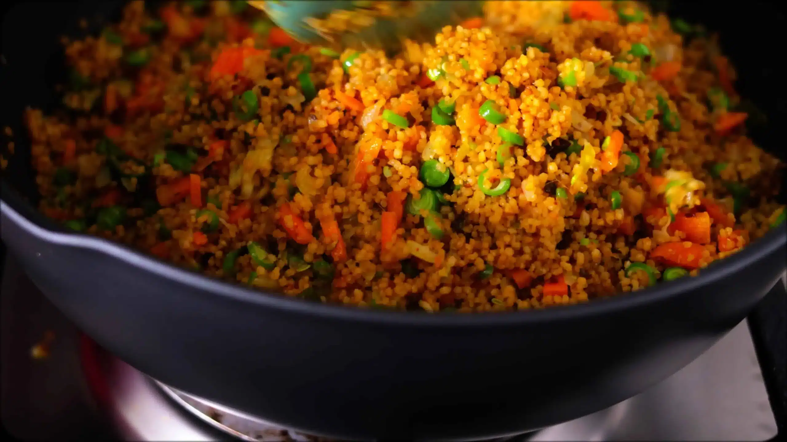 adding cooked couscous for making CousCous Fried Rice