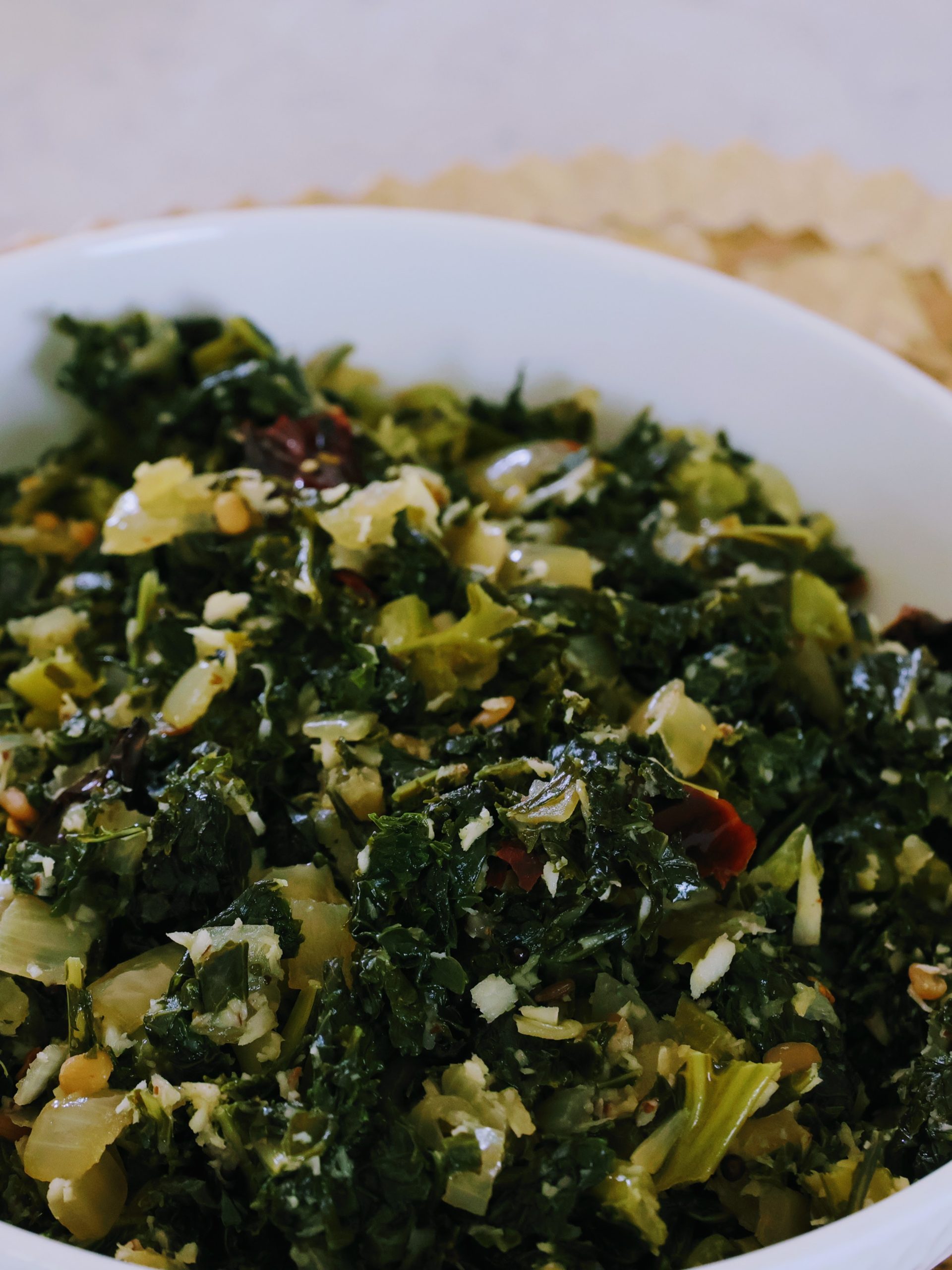 Kale stir fry with shredded coconut added in a bowl