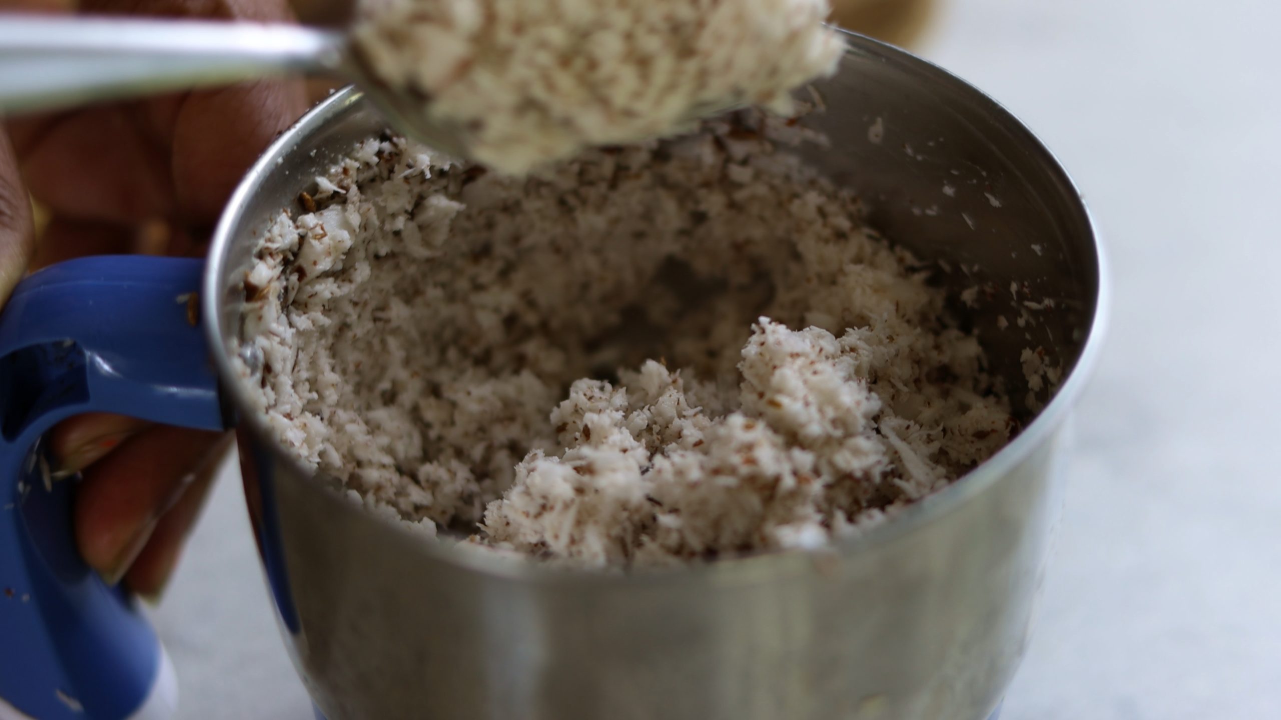 shredded coconut in a mixer grinder for making kale stir fry