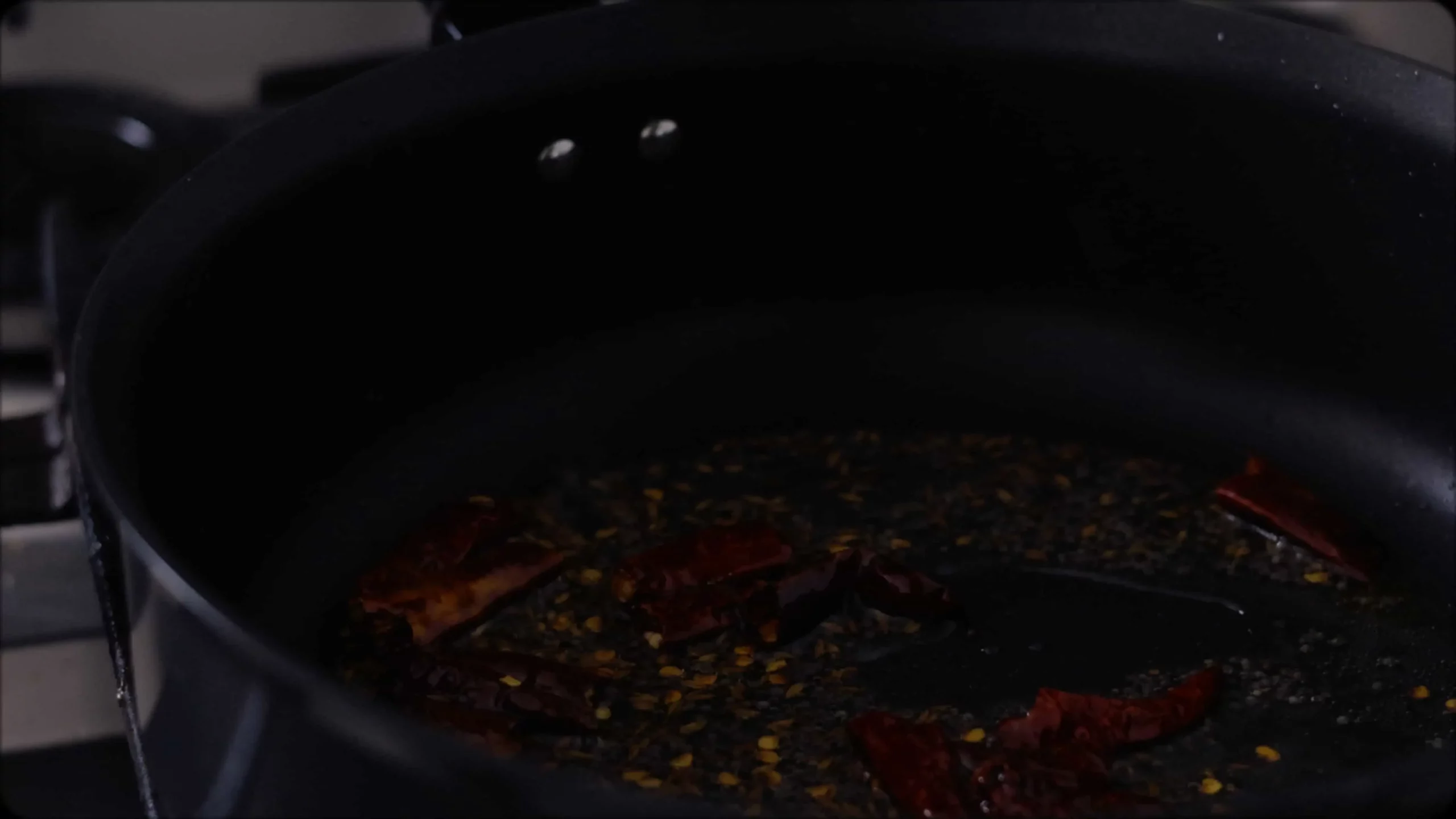 sauteeing with mustard, cumin seeds and red chillies for making methi dal