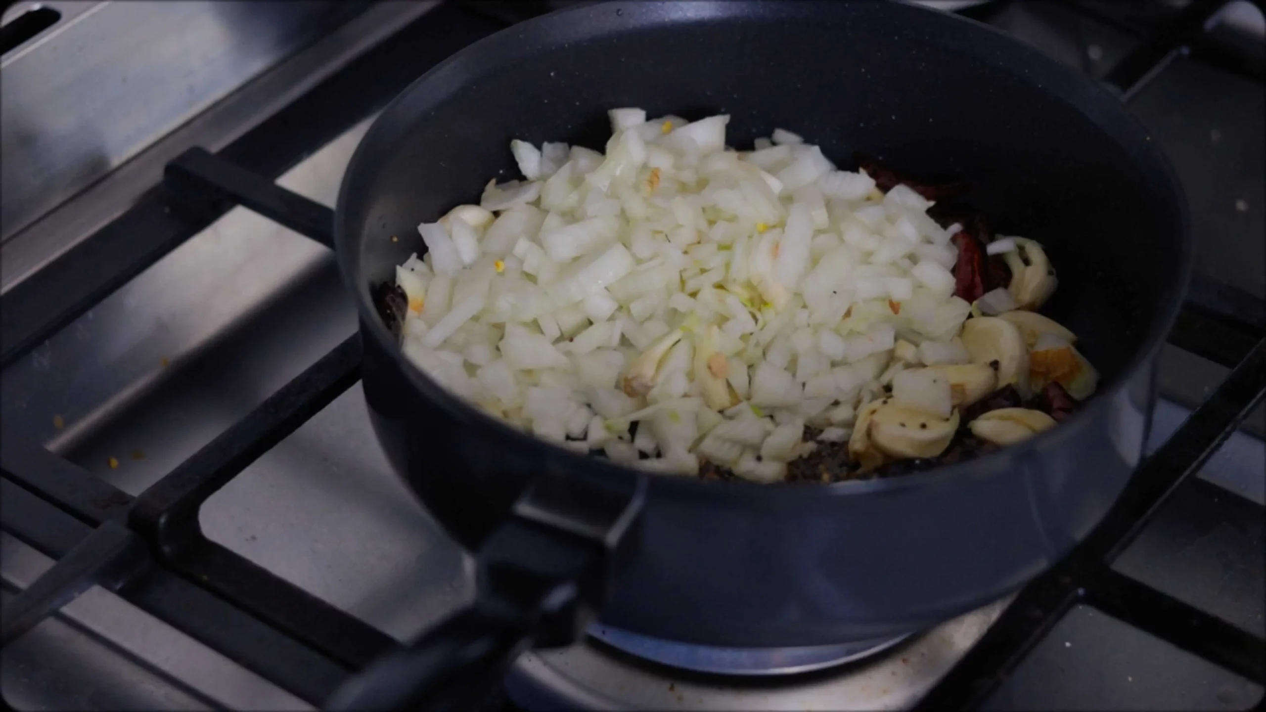 sauteeing with mustard, cumin seeds and red chillies, diced tomatoes for making methi dal