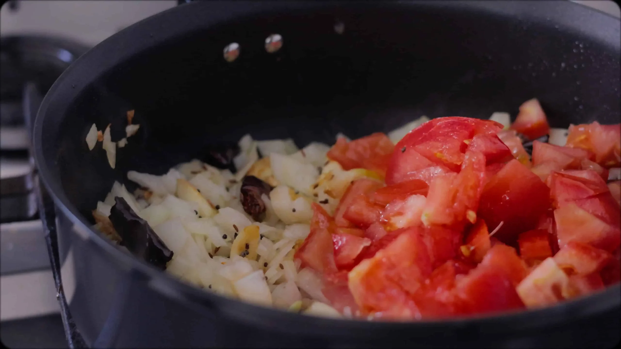 sauteeing with mustard, cumin seeds and red chillies, diced tomatoes for making methi dal