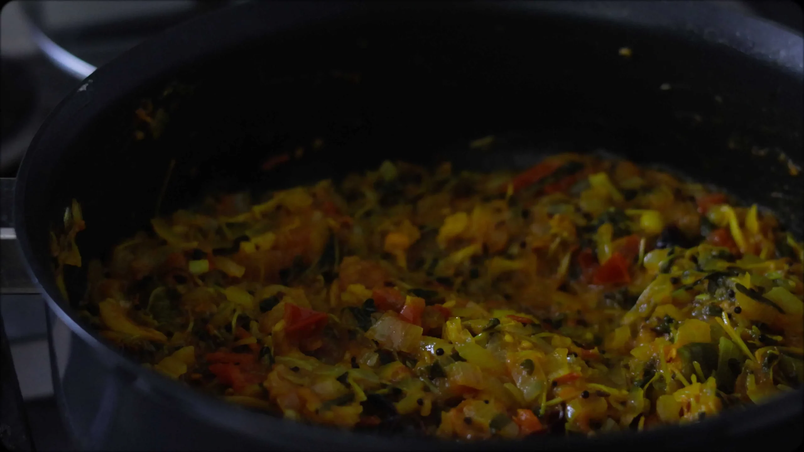 sauteeing with mustard, cumin seeds and red chillies, diced tomatoes for making methi dal