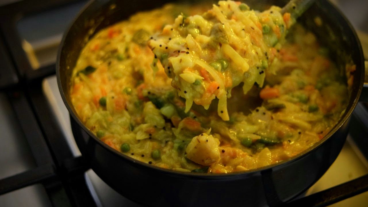 The vibrant yellow curry, made with potatoes, spices like cumin, fragrant curry leaves, chopped cilantro garnish. This classic Indian street food puri masala combines the perfect contrast of crisp pooris and flavorful, saucy curries.