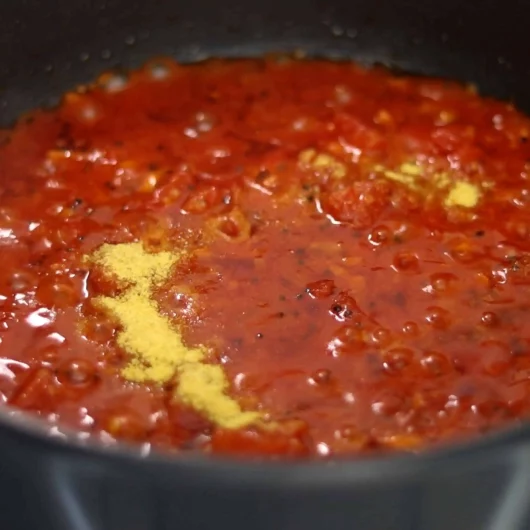 adding hing for making tin tomato pachadi