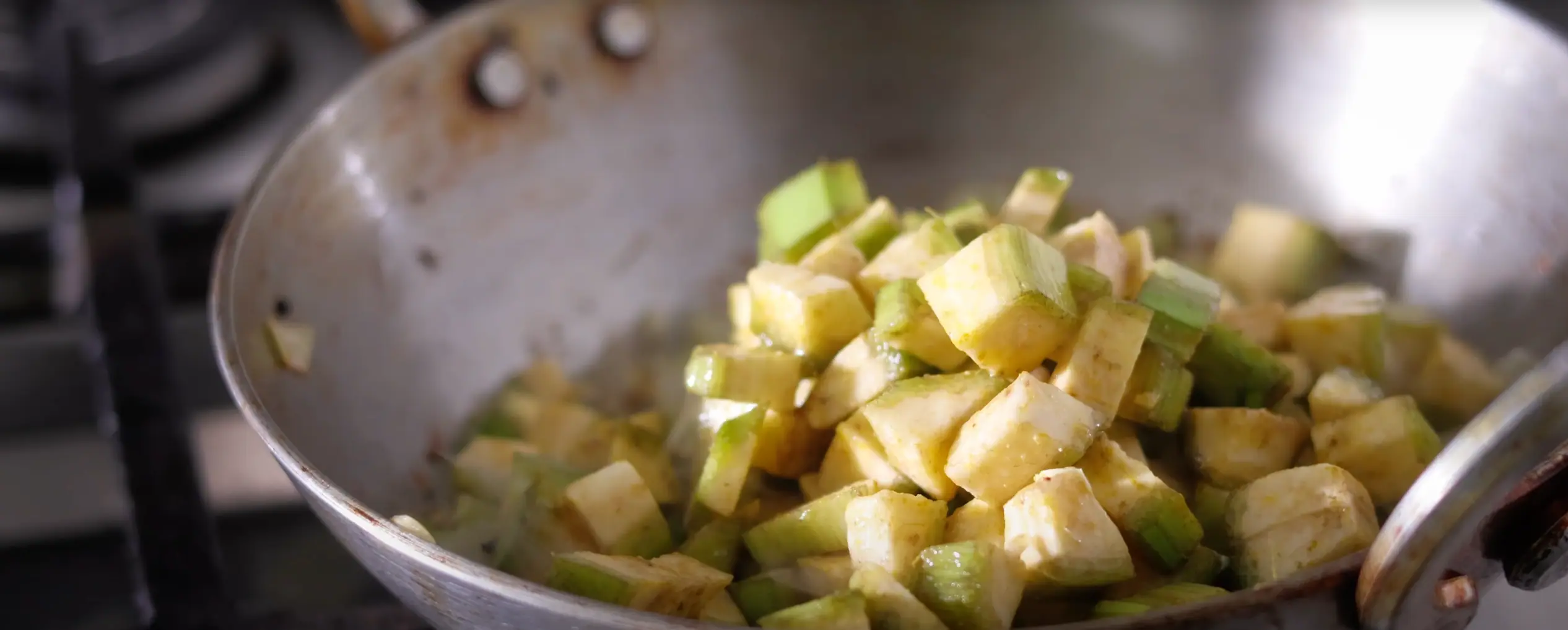 adding raw bananas for making aratikaya kura recipe