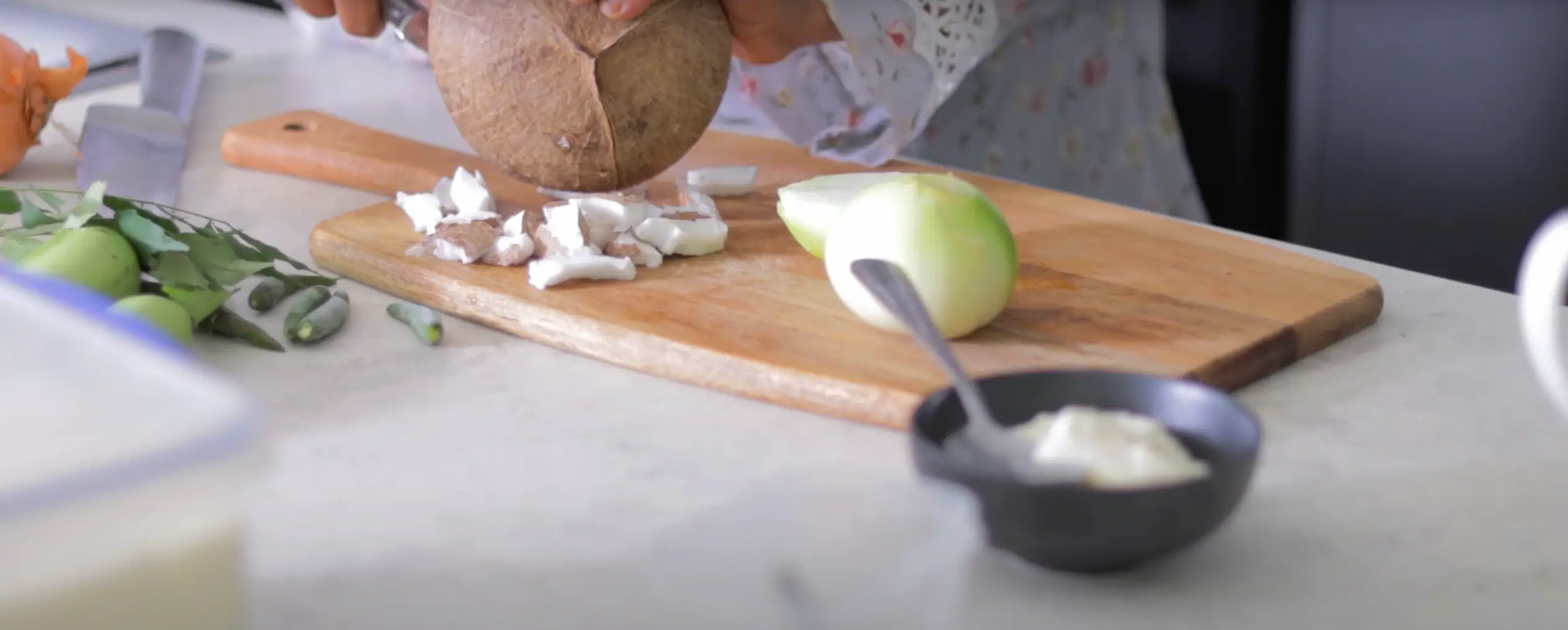 extracting fresh coconut chunks from coconut shell for aratikaya kura recipe