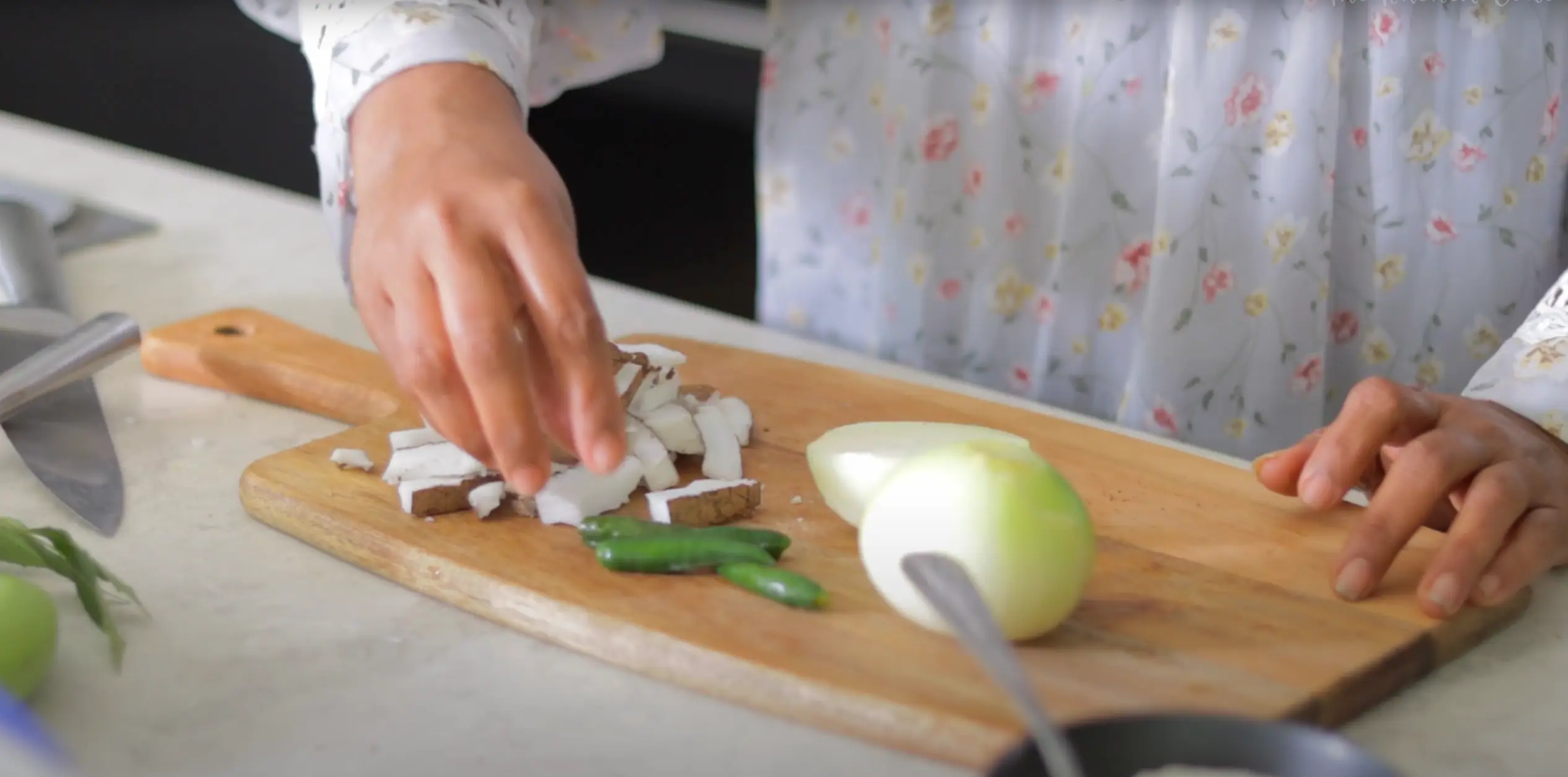 extracting fresh coconut chunks from coconut shell for aratikaya kura recipe