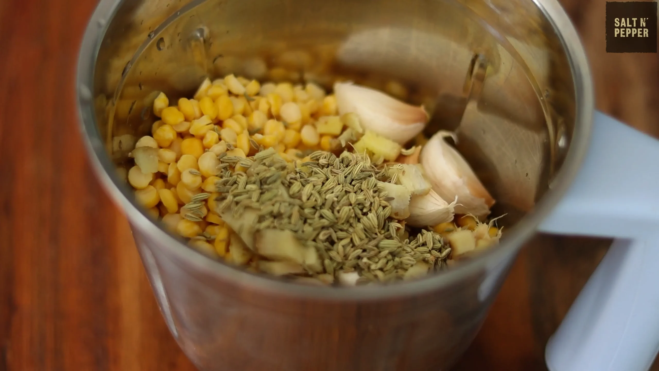 soaked chana dal or bengal gram for making parippu vada recipe with added fennel seeds, garlic